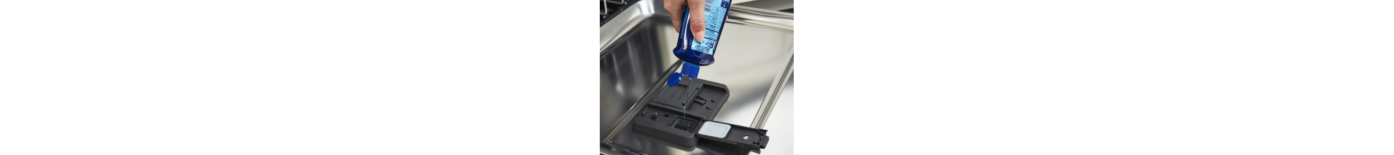 Person dispensing detergent into dishwasher