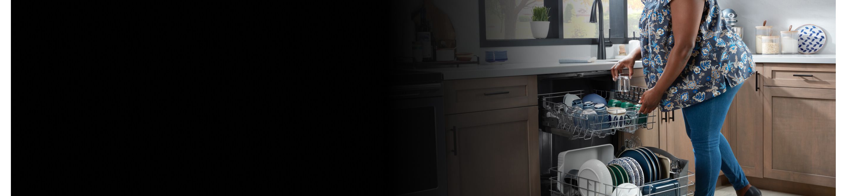 Person loading dishes into a Maytag® dishwasher