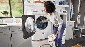 A person loading a Maytag® front-load washer