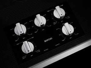 Close-up of Maytag® electric cooktop stainless steel knob controls