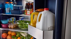 Open French door refrigerator stocked with in-door beverages
