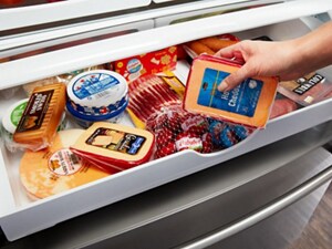 Maytag brand refrigerator’s deli drawer stocked with meats and cheeses