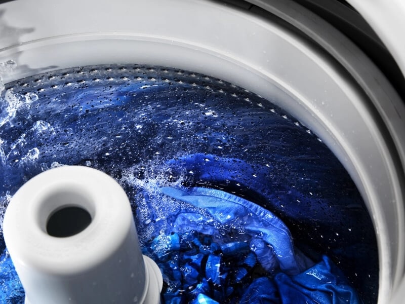 Clothes washing inside a top load washer with an agitator