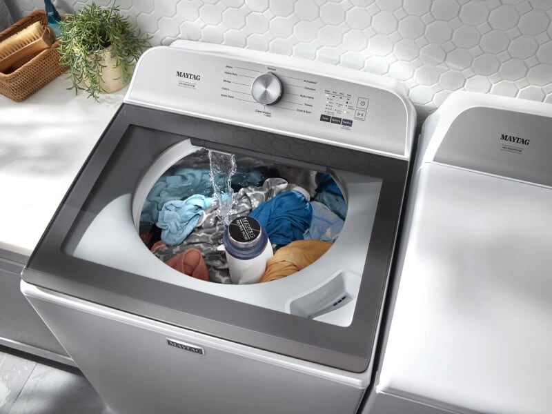 Birds-eye view of clothes agitating in a Maytag® top load washer