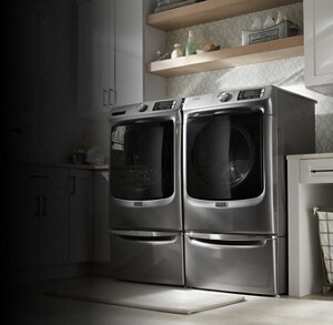 Maytag® front load washer and dryer on pedestals in a laundry room
