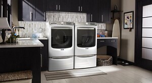 White Maytag® front load washer and dryer on pedestals in open laundry room