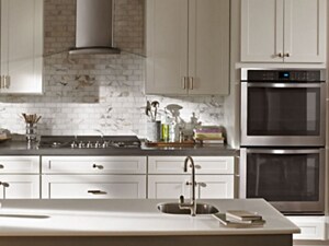 Range hood with a glass canopy above a gas stovetop