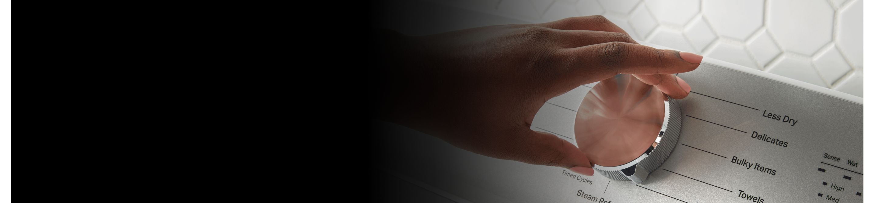 Hand making a dryer selection with a dial