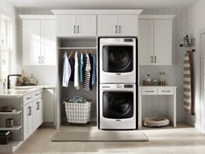 Stacked white Maytag® front load laundry pair in an open mud room