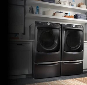 Front load washer and dryer pair on pedestals from Maytag brand