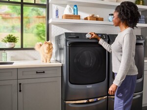 Person selecting settings on a Maytag® front load washer