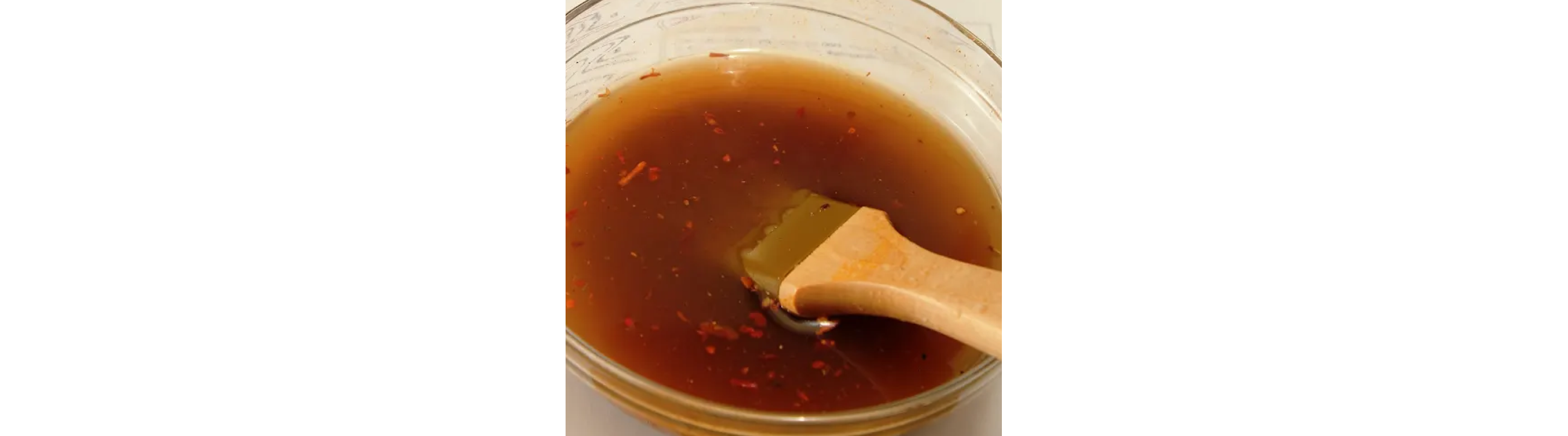  Basting brush inside a bowl of gravy mixture