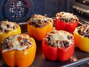 Stuffed peppers broiling in an oven