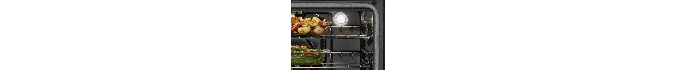 Oven light bulb illuminated with food on racks
