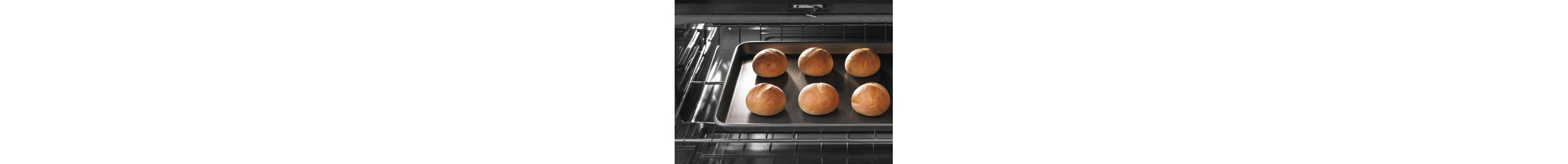 Oven light on with rolls on cookie sheet