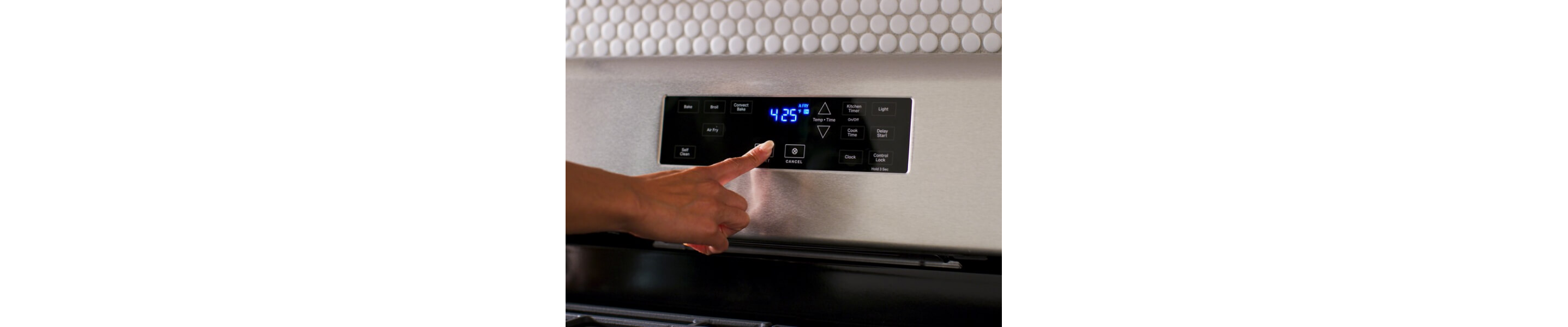 Close-up of person selecting settings on an electric control panel