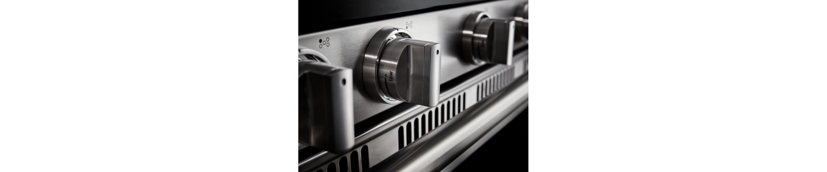 Close-up of control knobs for a gas stovetop