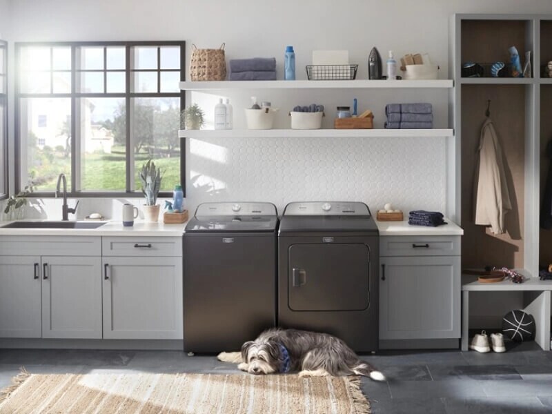 Maytag® top load washer and dryer pair in an open laundry room