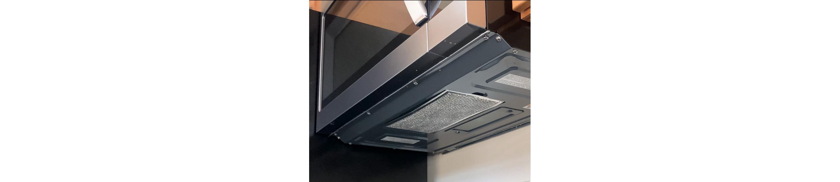 View of the bottom of the microwave showing location of the grease filter
