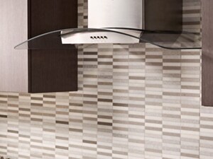 Glass wall mount range hood in a modern kitchen