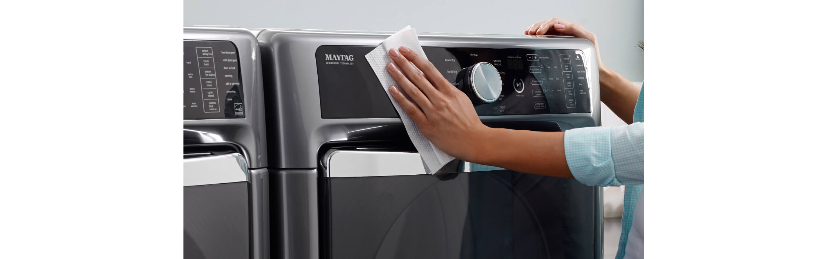 Person wiping outside of washing machine