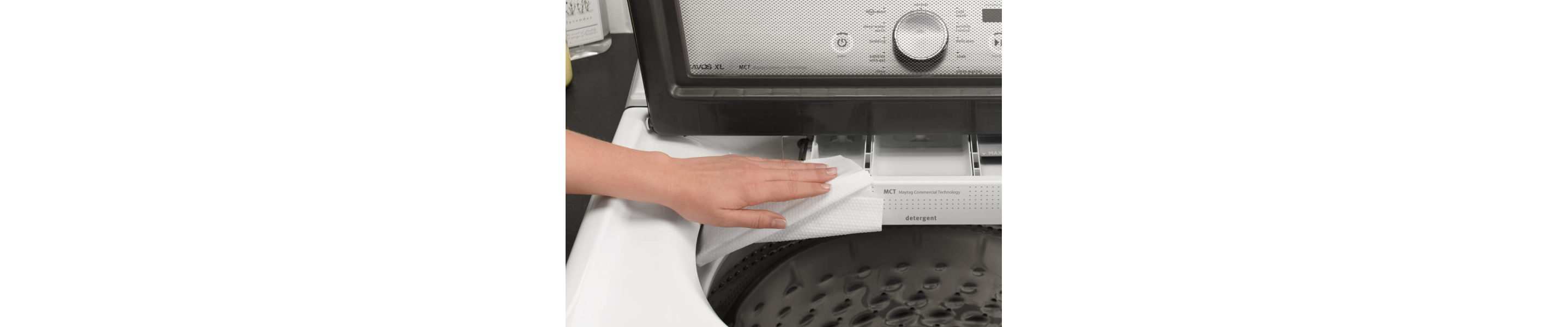 Person wiping detergent dispenser