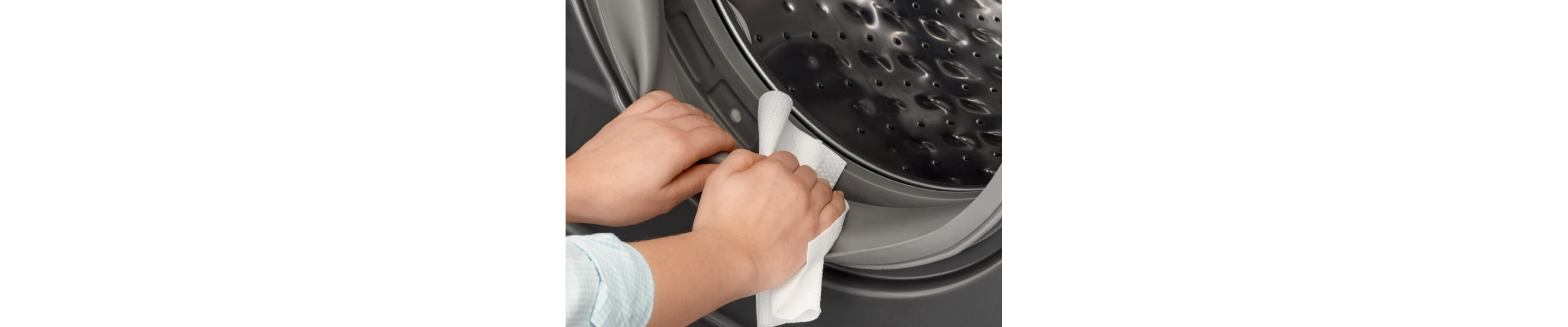 Person wiping inside of washing machine door