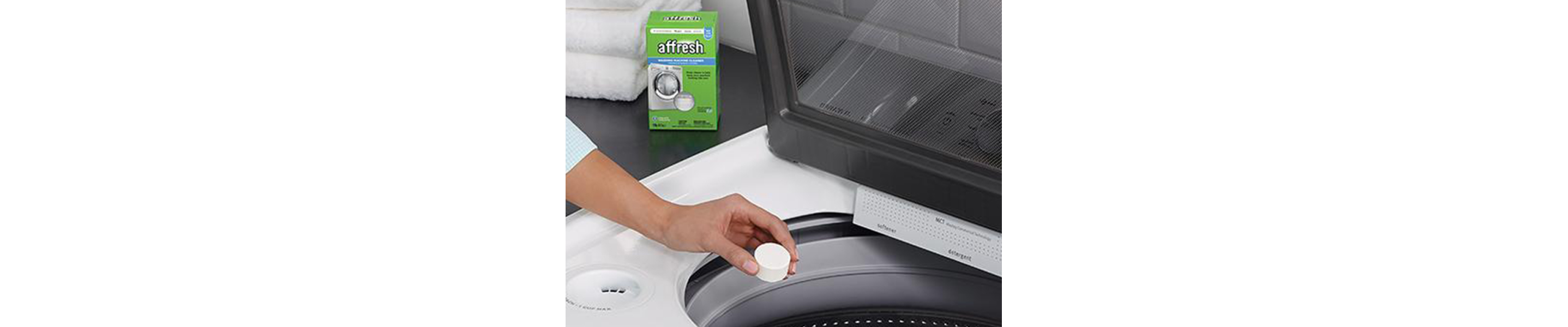 Person placing affresh® tablet in washing machine