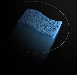A sponge, moving across a glass cooktop