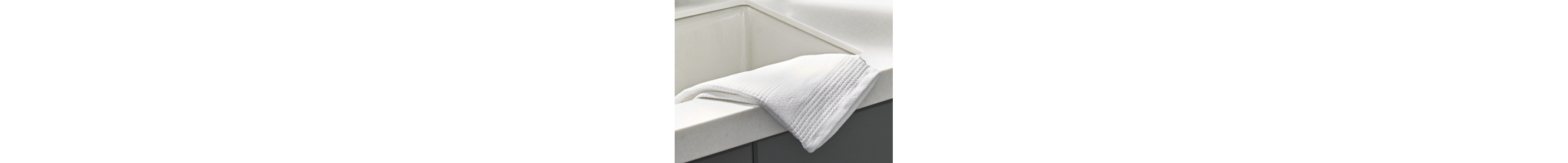 Towel laying on the edge of a kitchen sink