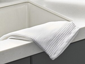 Towel placed on the edge of a kitchen sink