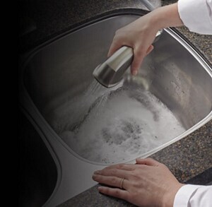 Person rinsing kitchen sink