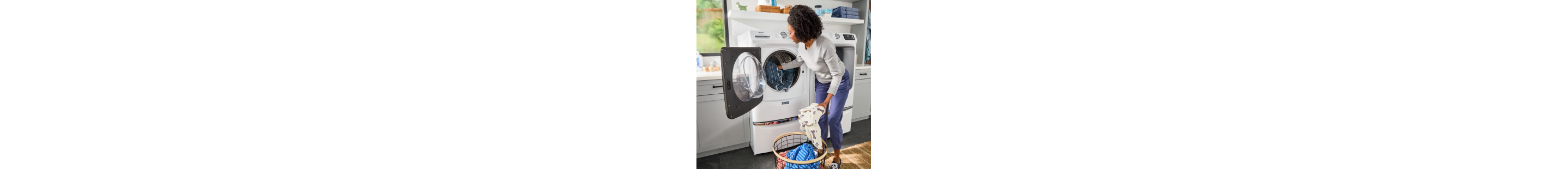 Person loading laundry into a front load washing machine
