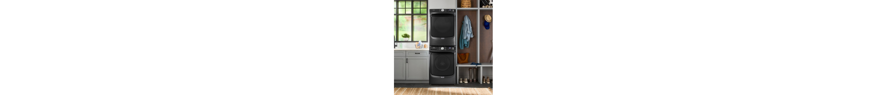 Stacked front load washer and dryer in a laundry room