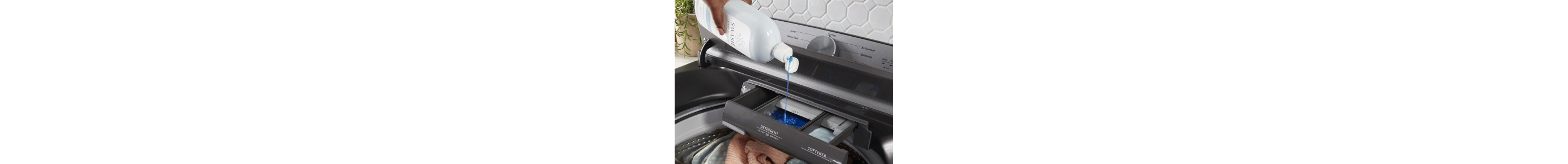 Hand pouring swash liquid detergent into washing machine