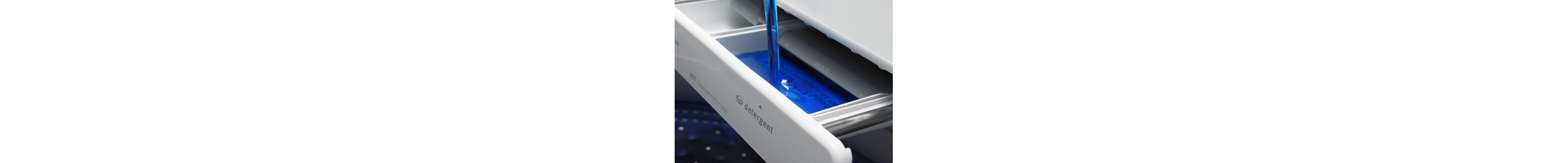 Detergent being poured into the HE slot in washing machine