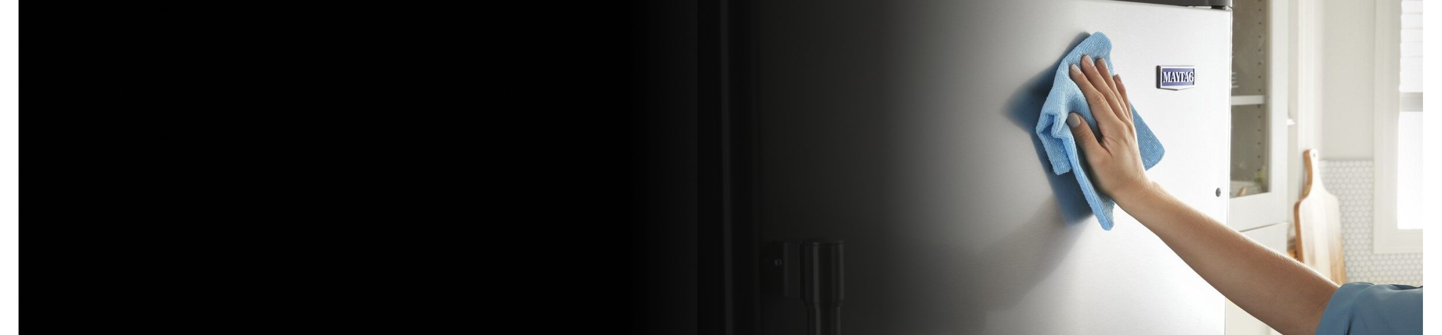 Person cleaning a stainless steel appliance