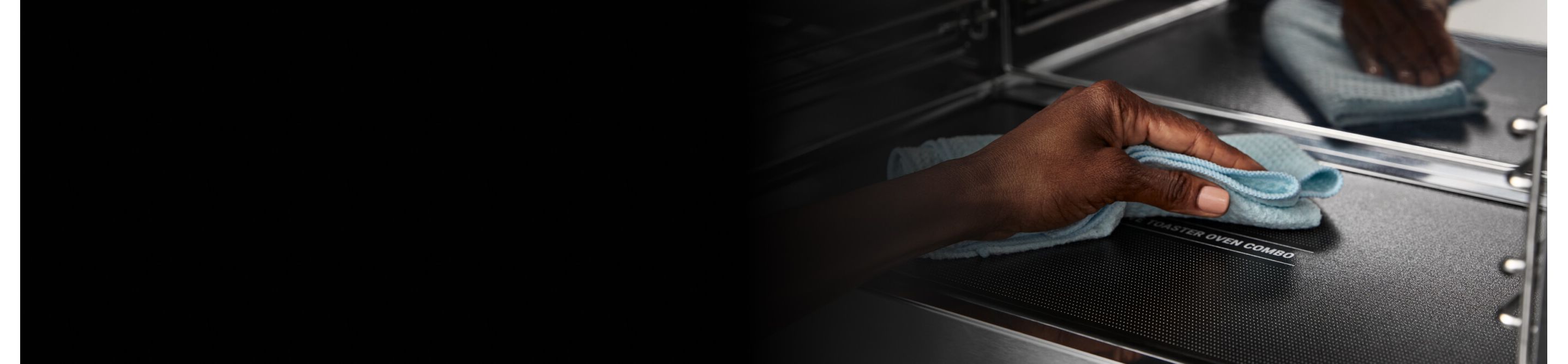 Person cleaning the inside of a Maytag® microwave 