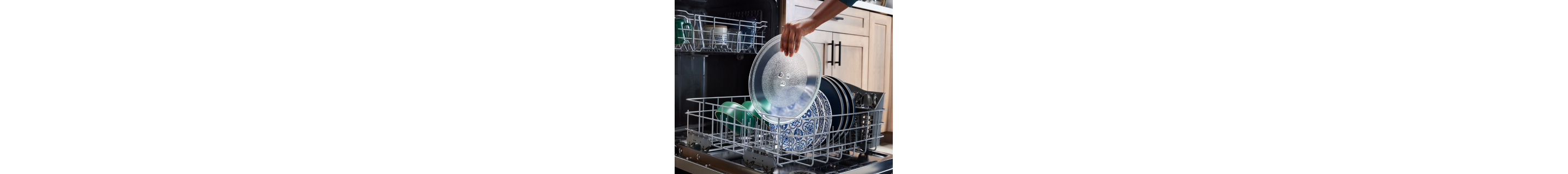 Person placing a microwave turntable in a dishwasher