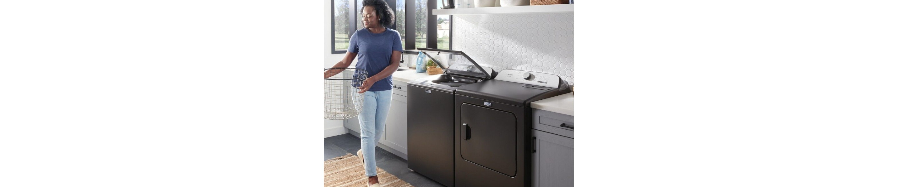 Woman standing next to open washer and dryer set