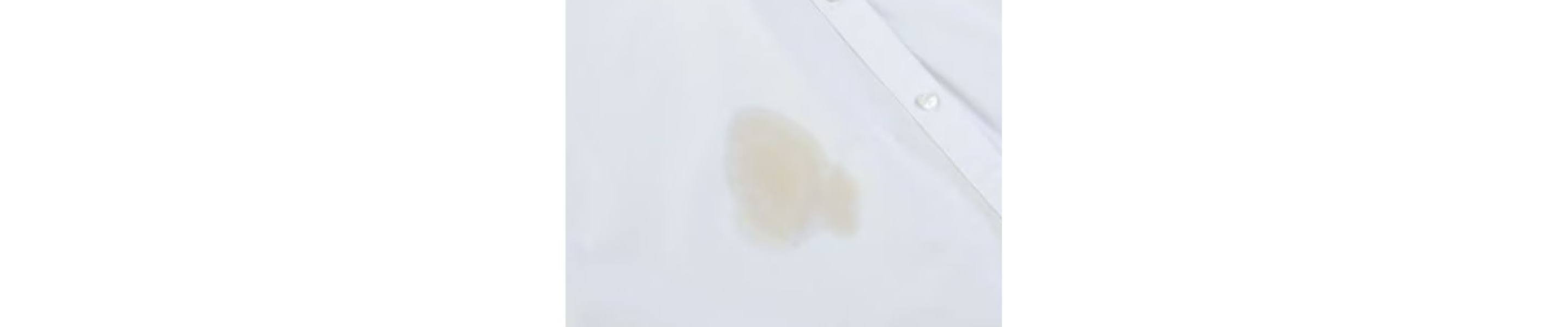 Close-up of coffee stain on white shirt