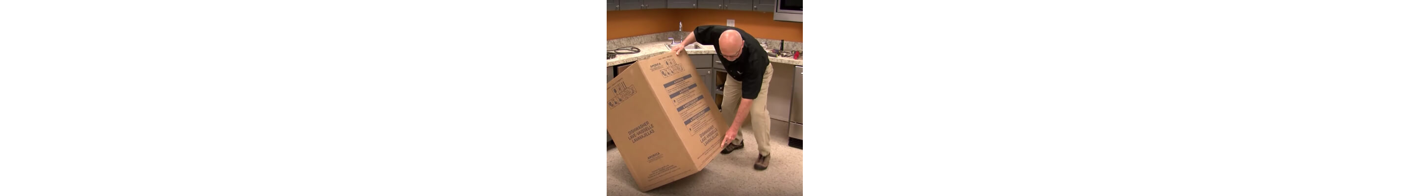 A person tilting a dishwasher cardboard box on its side