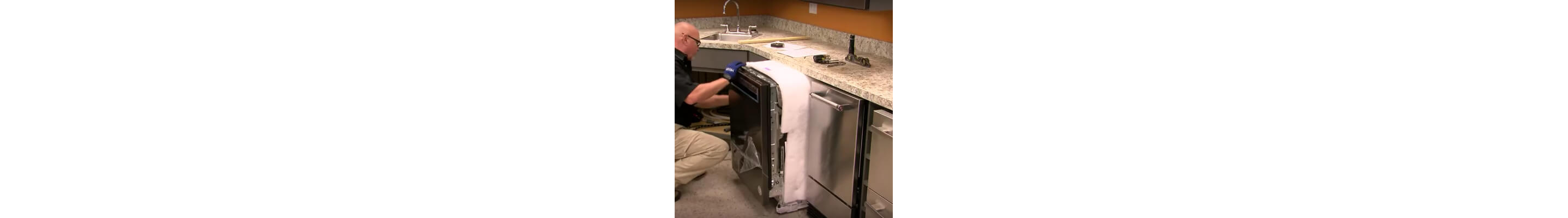 A person sliding a dishwasher into a cutout space