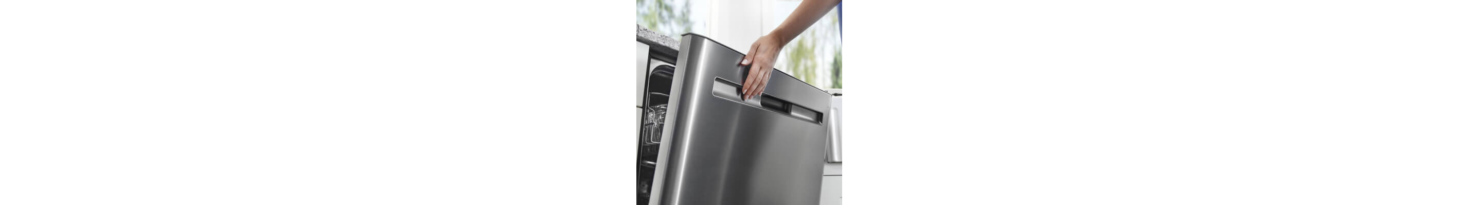 A close up of a hand closing a dishwasher door