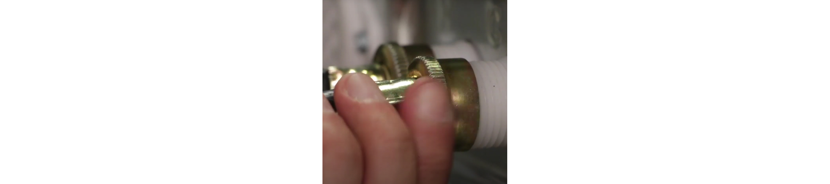 A water inlet hose being detached from a washer