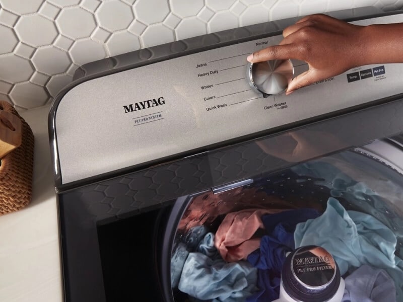 Person adjusting the controls on their Maytag® Pet Pro Washer