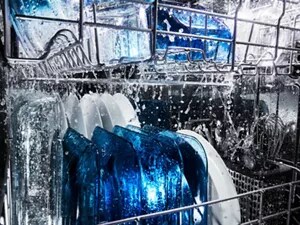 Plates and silverware washing inside a dishwasher