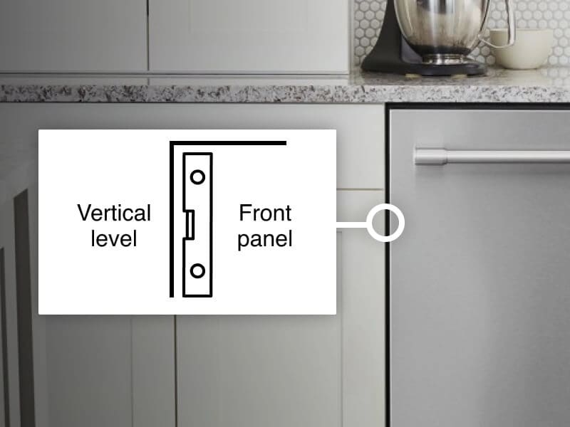 Vertical level against the front of a dishwasher