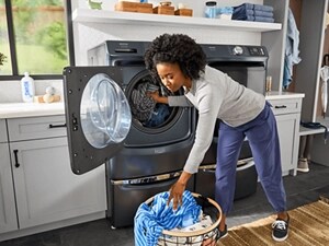 A person putting clothes in a washing machine