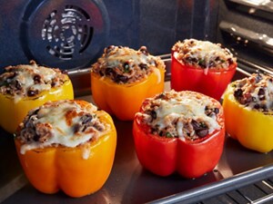 Stuffed peppers cooking in an oven